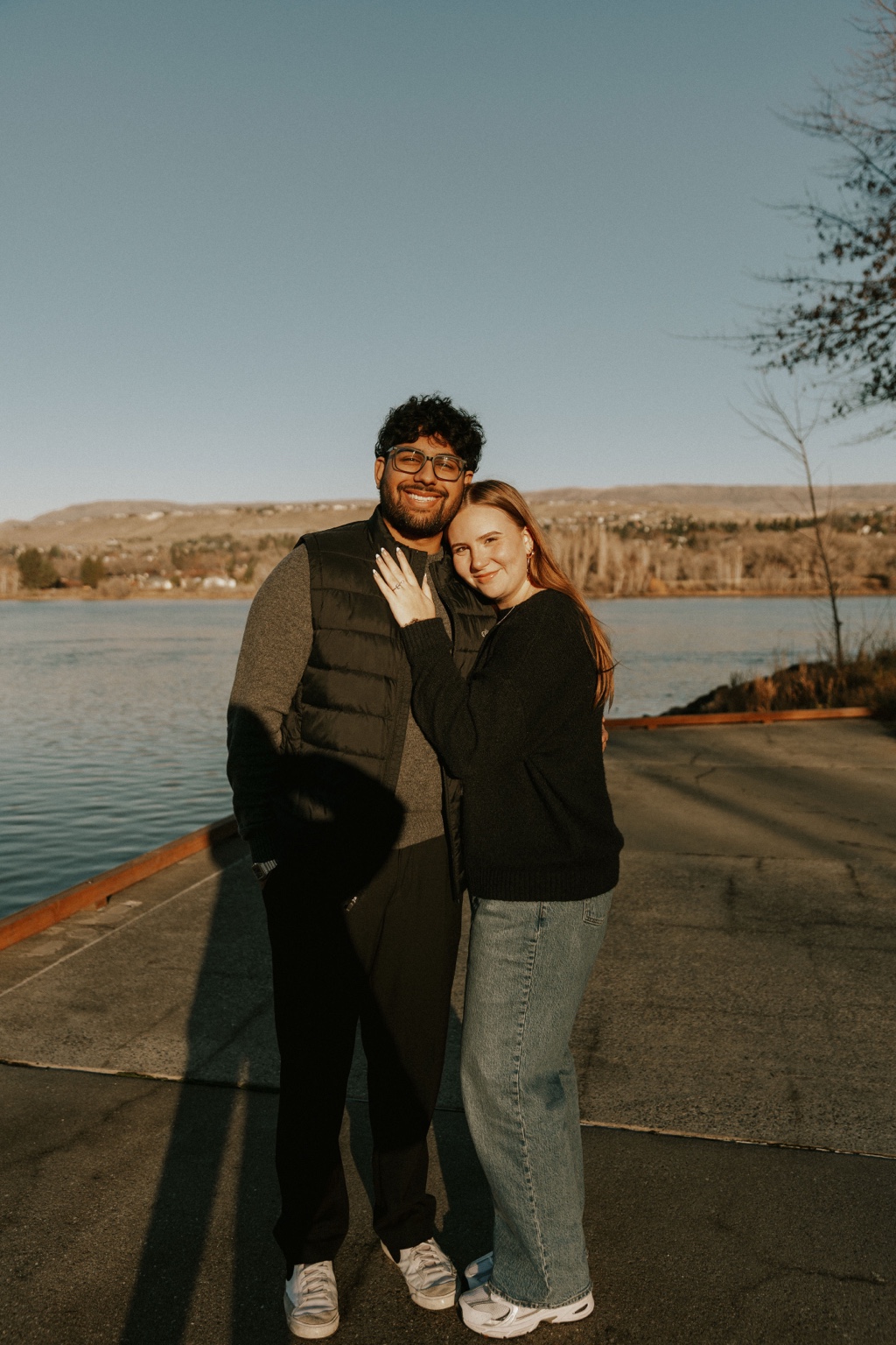 Harry and his fiancée standing together by the water.