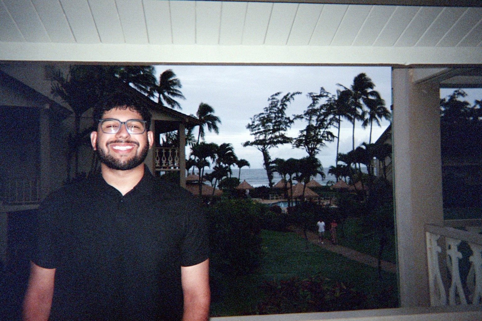 Harry at a tropical resort overlooking the water.